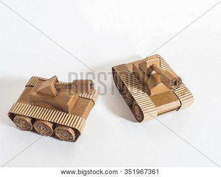 Two Toy Tanks Made By Children From Corrugated Cardboard Are Fighting. Toy Cardboard Tanks Isolated 