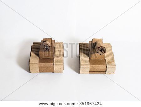 Two Toy Tanks Made By Children From Corrugated Cardboard Are Fighting. Toy Cardboard Tanks Isolated 