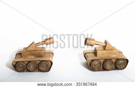 Two Toy Tanks Made By Children From Corrugated Cardboard Are Fighting. Toy Cardboard Tanks Isolated 