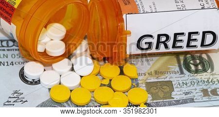 Greed Is Written On To One Prescription Bottle And Pills Spilling Out On Toe Dollat Bills Of A Senco