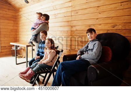 Mother And Kids In Modern Wooden House, Spending Time Together In Warm And Love.