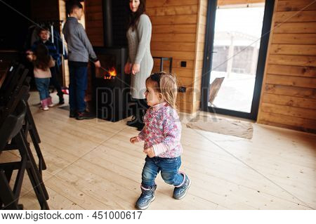 Mother And Four Kids In Modern Wooden House Against Fireplace, Spending Time Together In Warm And Lo