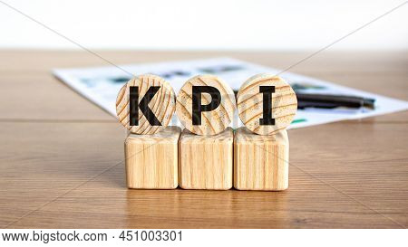 Kpi, Key Performance Indicator Symbol. Concept Word Kpi, Key Performance Indicator On Wooden Circles