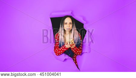 Woman With Toy House Looking Through Hole In Paper. Female With Afro Braids And Miniature Wooden Hou