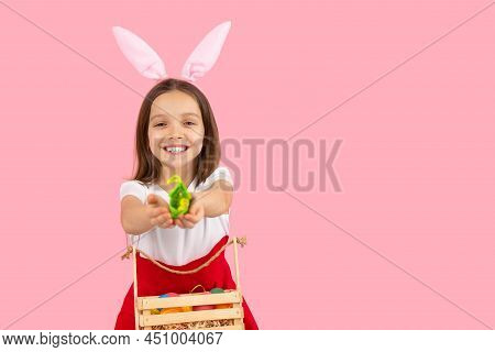 Cheerful Little Girl Widely Smiling Wearing Bunny Ears On Head In Dress With Basket Ful Of Painted E
