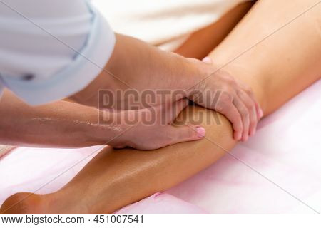 Facial Massage. A Woman Is Given A Massage In A Beauty Salon. Close-up.