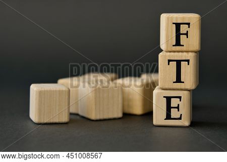 Fte (full-time Equivalent) - Acronym On Wooden Cubes On A Dark Background. Business Concept