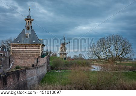 View Of Historical City Gate Known Locally As Dalempoort And An Old Windmill In The City Of Gorinche