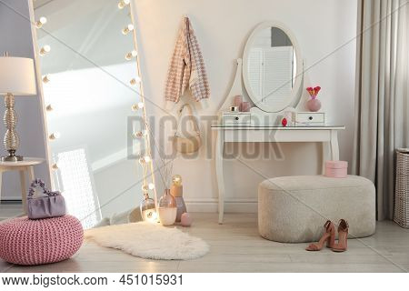 Large Mirror With Light Bulbs And Dressing Table In Stylish Room. Interior Design