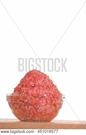 Minced Pork. Fresh Raw Minced Meat Close-up In A Transparent Cup On A Wooden Table Isolated On White