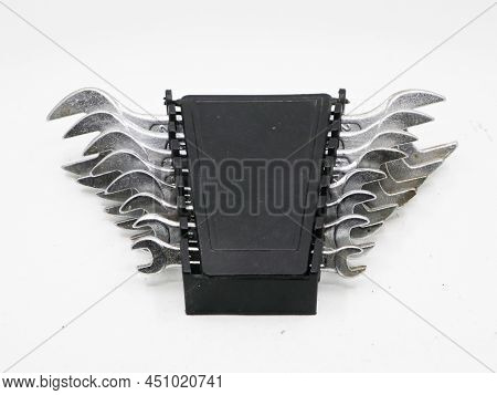 An Old Tool Set Of Stainless Steel Spanners In A Black Box Isolated In A White Background