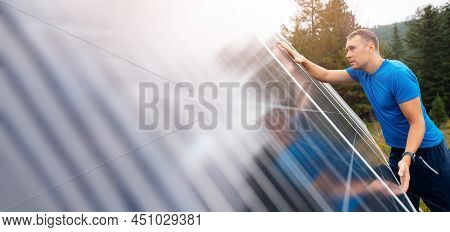 Male Farmer Independently Installs And Connects Electrical Panels On Suburban Area In Mountain For S