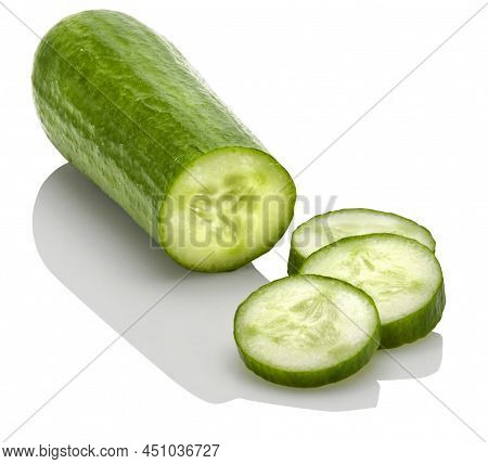 A Chopped Mini Cucumber On A White Background With A Reflection