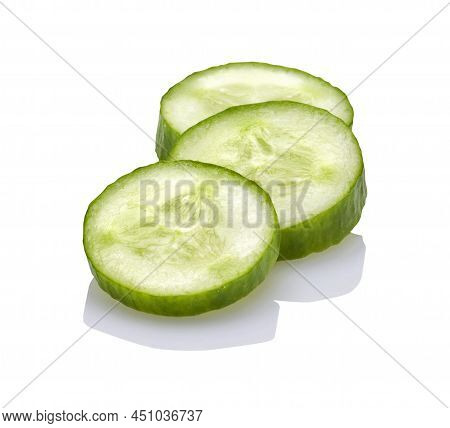 Three Slices Of Fresh Mini Cucumber On A White Background