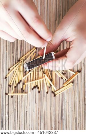 A Child Looks And Plays With Matches, A Dangerous Activity For A Toddler At Home