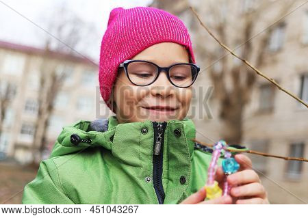Girl And Child Playing With A Toy On The Street