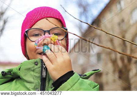 Girl And Child Playing With A Toy On The Street