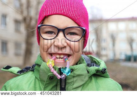 Girl And Child Playing With A Toy On The Street