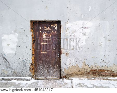 An Old Door Provides Access To A Cracked Building