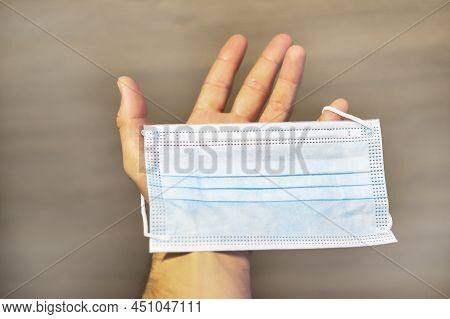 A Helping Hand Always Holds Out A Medical Mask To Patient