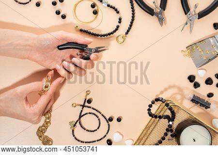 Tools And Accessories For Diy Jewelry In The Workplace. Female Hand With Wire Cutters.flat Lay On Be