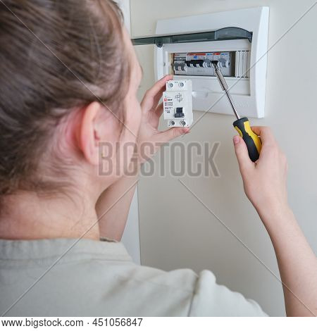 A Woman Changes An Automatic Fuse Ekf In A Home Electrical Panel. Self Repair And Replacement Of Ele