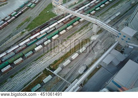 Aerial View Of Cargo Train Cars Loaded With Construction Goods At Mining Factory. Railway Transporta