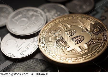 Bitcoin Crypto Currency Coin Virtual Money And Russian Rubles On Dollars Banknotes.
