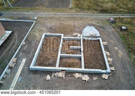 Top Down Aerial View Of Building Works Of New House Concrete Foundation On Construction Site.