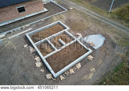 Top Down Aerial View Of Building Works Of New House Concrete Foundation On Construction Site.