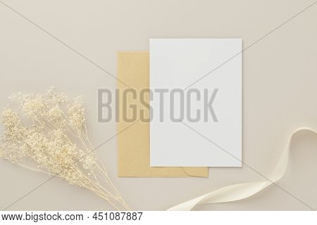 Blank Greeting Card Invitation Mockup 5x7 On Brown Envelope With Dried Flowers On Beige Background, 