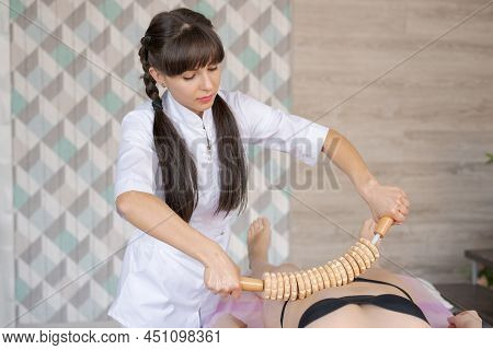 Close-up On Belly Woman Having Anti-cellulite Massage Session With Madero Therapy, Professional Ther
