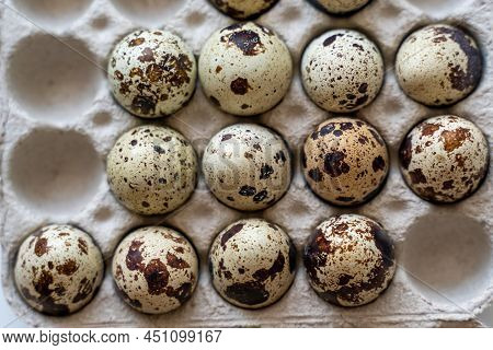 Spotted Quail Eggs In An Egg Box On A Light Background, Natural Eco-friendly Products.