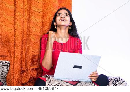 Celebrating Young Teenger Girl While Using Laptop At Home - Concept Of Got Job Or Exam Results, Won 