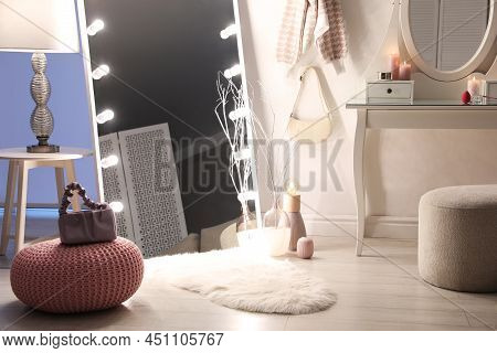 Large Mirror With Light Bulbs And Dressing Table In Stylish Room. Interior Design