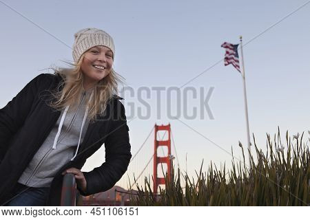 View Of A Young Girl In Black Coat Near Golden Gate In San Francisco