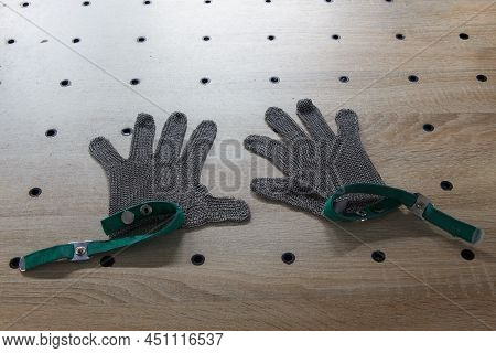 Metal Protective Gloves On Cutting Table Of Tape Cutting Machine.