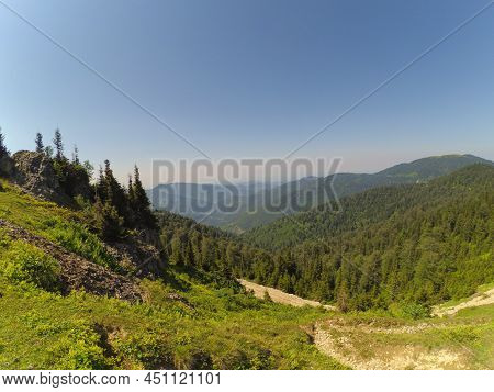 Landscape Of Forest And Mountains With Blue Sky. View Of From A Hill. Concept Of Freedom In Mountain
