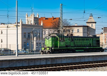 Jaworzyna Slaska, Poland - April 2021: Green Locomotive Of Cargo Train Ride On Rails Next To Platfor