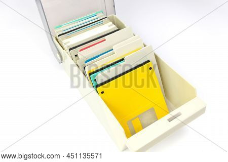 A Storage Box Of 3.5 Inch Floppy Disks For Background. Retro Digital Storage Technology.