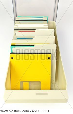 A Storage Box Of 3.5 Inch Floppy Disks For Background. Retro Digital Storage Technology.