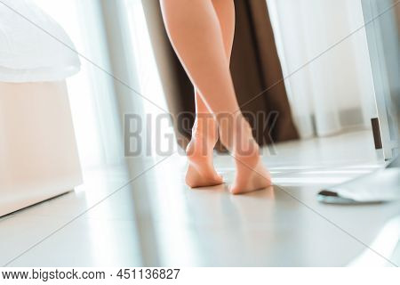 Fit And Sexy Woman With Curly Hair Laying Among Bed Sheets Wearing Lace Lingerie.