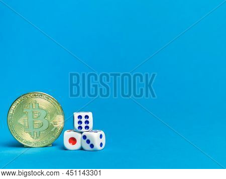 Photo Of Bitcoins And Dices Against Blue Background.