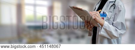 Doctor Checking And Writing About Patient's Health At Hospital. Health And Wellness.