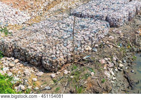 Stone Walls, Protection From Backshore Erosion. Stones In A Metal Mesh. Gabion Wall Constructed Usin