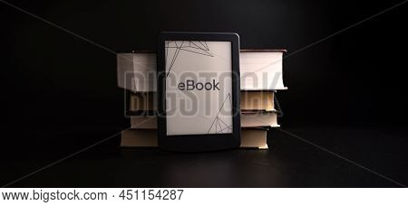 E Reader. Digital E Book, Library Reader Tablet With Books On Dark Background. Online Education Cour