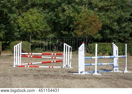 Show Jumping Poles Obstacles, Barriers, Waiting For Riders On Show Jumping Training. Horse Obstacle 