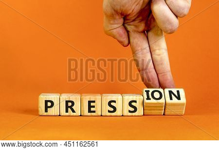 Pression To Free Press Symbol. Businessman Turns Wooden Cubes, Changes The Word Pression To Press. B