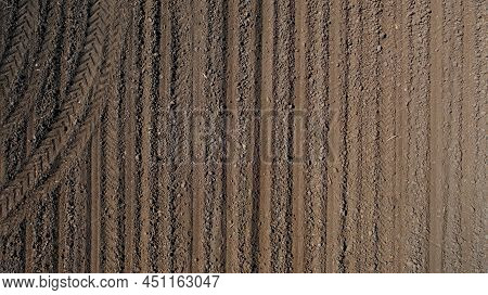 Farming: A Farmer On A Tractor Works The Field Before Sowing