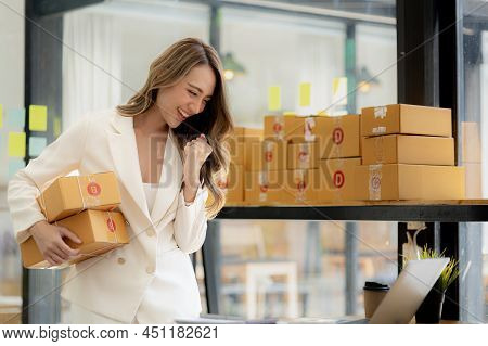 A Woman Who Owns An Online Store Showing A Happy Expression, She Is Checking Orders From Customers,